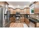 Kitchen with light wood cabinets, granite countertops, and stainless steel appliances at 1058 Magnolia Dr, Villa Rica, GA 30180