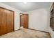 Well-lit bedroom with wood doors and neutral carpet at 3409 Shorelake Dr, Tucker, GA 30084