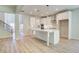 Modern kitchen with white cabinets, large island, and stainless steel appliances at 509 Dolce Rd, Locust Grove, GA 30248