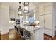 Modern white kitchen with marble countertops, stainless steel appliances, and ample storage at 11 Old Paces Nw Pl, Atlanta, GA 30327