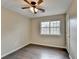 Spacious bedroom with ceiling fan, window, and wood-look floors at 4684 Pine Dr, Loganville, GA 30052