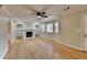 Spacious living room featuring hardwood floors, a fireplace, and built-in shelving at 4684 Pine Dr, Loganville, GA 30052