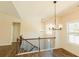 Bright dining room with hardwood floors, chandelier, and view of staircase at 5965 Crowley Dr, Douglasville, GA 30135