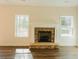 Stone fireplace with white mantel in a living room with LVP flooring at 5965 Crowley Dr, Douglasville, GA 30135