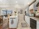 Basement kitchenette with white cabinets, island, and a view into game room at 465 Verdi Ln, Sandy Springs, GA 30350