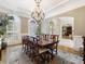 Elegant dining room with chandelier and seating for eight at 465 Verdi Ln, Sandy Springs, GA 30350