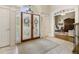 Bright and spacious foyer with double doors and view into living room at 465 Verdi Ln, Sandy Springs, GA 30350