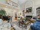 Bright living room with high ceilings, fireplace, and built-in shelving at 465 Verdi Ln, Sandy Springs, GA 30350