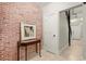 Inviting entryway with exposed brick wall and stylish console table at 5512 Glenridge Ne Dr # E, Sandy Springs, GA 30342