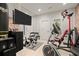 Home gym featuring a large TV, Bowflex, and stationary bike at 5512 Glenridge Ne Dr # E, Atlanta, GA 30342