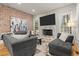 Spacious living room with a fireplace, large sectional sofa, and hardwood floors at 5512 Glenridge Ne Dr # E, Sandy Springs, GA 30342