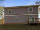 Gray siding two story home with a deck and wooded backyard at 60 Hammock Dr, Covington, GA 30016