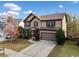 Two-story house with brown and beige siding, a large garage, and landscaping at 904 Berry Ct, Canton, GA 30114