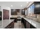 Kitchen with dark cabinetry, granite countertops, and stainless steel appliances at 904 Berry Ct, Canton, GA 30114