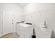Laundry room with washer, dryer, utility sink, and shelving at 904 Berry Ct, Canton, GA 30114