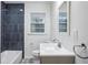 Modern bathroom with herringbone floor and updated vanity at 1690 Creveis Rd, Austell, GA 30168