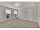 Well-lit bedroom with two windows and neutral carpeting at 147 Stargaze Rdg, Canton, GA 30114