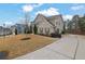 Two story house with neutral siding and brick accents, landscaping and driveway at 147 Stargaze Rdg, Canton, GA 30114