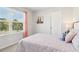 Bedroom with a soft pink bedspread, coral curtains, and a window at 1462 Stephens View Dr, Loganville, GA 30052