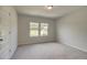 Well-lit bedroom with double windows and neutral colored carpet at 72 Homesite Corner Lot, Fayetteville, GA 30215