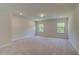 Bright bedroom with neutral walls and carpet, featuring two large windows at 72 Homesite Corner Lot, Fayetteville, GA 30215