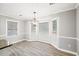 Bright dining room with bay window, chandelier, and wood-look flooring at 4120 Grady Smith Rd, Loganville, GA 30052