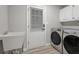 Laundry room with washer, dryer, and utility sink at 4120 Grady Smith Rd, Loganville, GA 30052