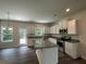 Kitchen with white cabinets, granite counters, and island at 5555 Bent Grass Way, Douglasville, GA 30135