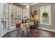 Charming breakfast nook with a rustic table and plenty of natural light at 1008 Ashfern Walk, Woodstock, GA 30189