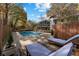 Pool with lounge chairs on a wooden deck, wooden fence, and trees at 4107 Winding Valley Se Dr, Smyrna, GA 30082