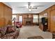 Living room with wood paneling and fireplace at 4975 Fox Forest Dr, Lilburn, GA 30047