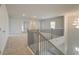 Upstairs hallway with carpet and access to bedrooms at 2376 Cadenza Cir, Dacula, GA 30019