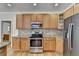 Kitchen features stainless steel appliances and wood cabinets at 4949 Moore Rd, Suwanee, GA 30024