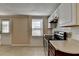 Galley kitchen with stainless steel appliances and a window at 4949 Moore Rd, Suwanee, GA 30024