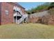 Landscaped backyard with stone retaining wall at 55 Rocky Ne Cir, White, GA 30184