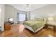 Bright bedroom with hardwood floors, a queen bed, and ensuite bathroom access at 55 Rocky Ne Cir, White, GA 30184