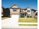 Two-story house with stone and siding, two-car garage, and manicured lawn at 106 Cottontail Ln, Loganville, GA 30052