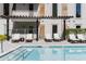 Relaxing pool area with modern lounge chairs and pergola at 775 Juniper Ne St # 111, Atlanta, GA 30308