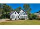 Two story house with white brick and black accents, a two car garage and manicured lawn at 227 Scenic View Lane Ln, Stone Mountain, GA 30087