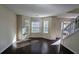 Sunlit living room with hardwood floors and bay windows at 325 Othello Dr, Hampton, GA 30228