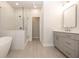 Spa-like bathroom with soaking tub, shower, and gray vanity at 280 Briscoe Way # 38, Alpharetta, GA 30009