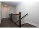 Upper hallway with dark hardwood floors and simple railing at 280 Briscoe Way # 38, Alpharetta, GA 30009