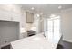 Modern kitchen with white cabinets, quartz countertops and island at 280 Briscoe Way # 38, Alpharetta, GA 30009