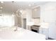 Modern kitchen with white cabinets, quartz countertops and island at 280 Briscoe Way # 38, Alpharetta, GA 30009