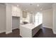 Modern kitchen with white cabinets, quartz countertops and island at 280 Briscoe Way # 38, Alpharetta, GA 30009
