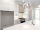 Modern kitchen with white cabinets, quartz countertops and island at 280 Briscoe Way # 38, Alpharetta, GA 30009
