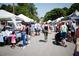 Outdoor farmer's market with various vendors and shoppers at 280 Briscoe Way # 38, Alpharetta, GA 30009