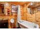 Charming basement bathroom with clawfoot tub and wood walls at 835 Timber Lake Trl, Cumming, GA 30041