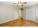 Bedroom with wood-look floors, ceiling fan, and double-door closet at 2485 Brentwood Rd, Decatur, GA 30032