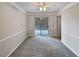 Bright dining room with gray carpet, chair rail molding, and sliding glass doors to a deck at 320 Kimberly Forest Ct, Atlanta, GA 30349